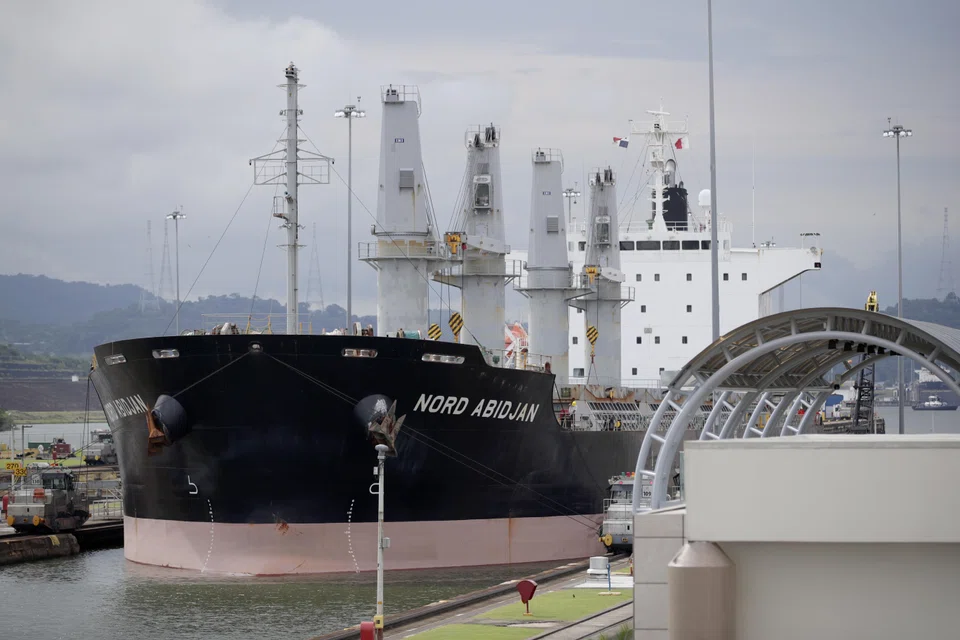 A ship transits through the Miraflores locks in the Panama Canal. The waterway is experiencing its worst drought in 70 years, leading to a backlog of vessels and long waiting periods.