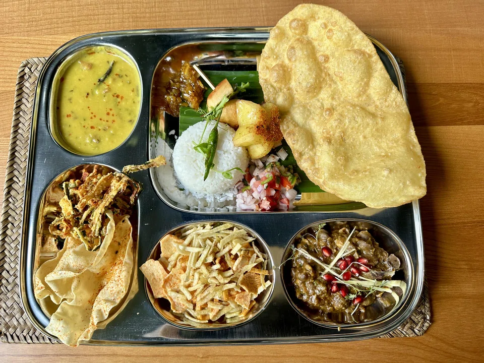 The lunch thali features individual dishes from different parts of India.