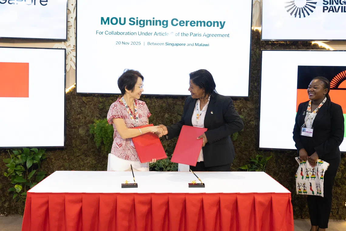 Singapore Sustainability and the Environment Minister Grace Fu (left) and Malawi Natural Resources, Energy and Mining Minister Jean Mathanga at the MOU signing in Belem, Brazil.