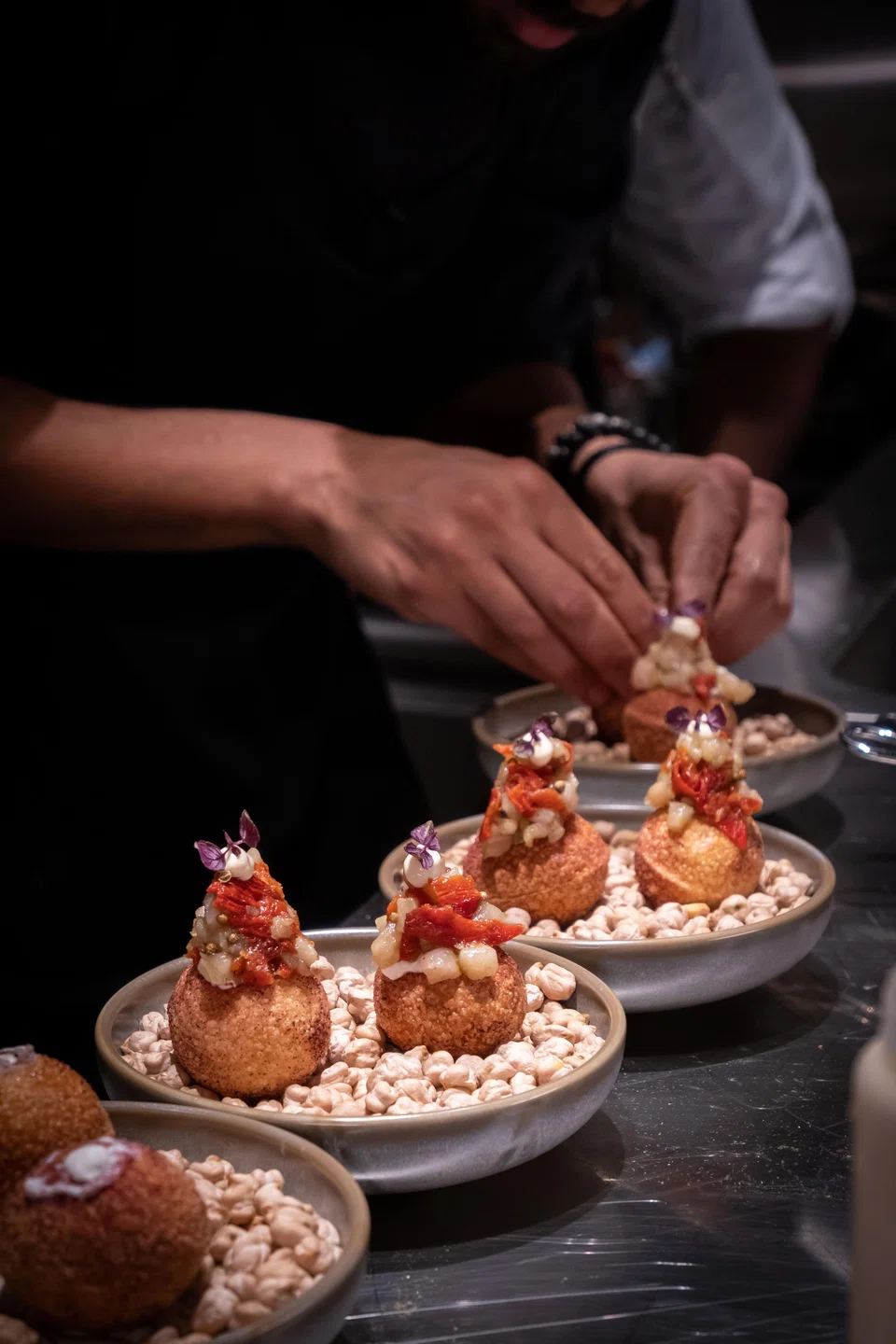 Pani Puri are filled with tangy whipped yoghurt, minced raw hamachi, green chillies and tomatoes.