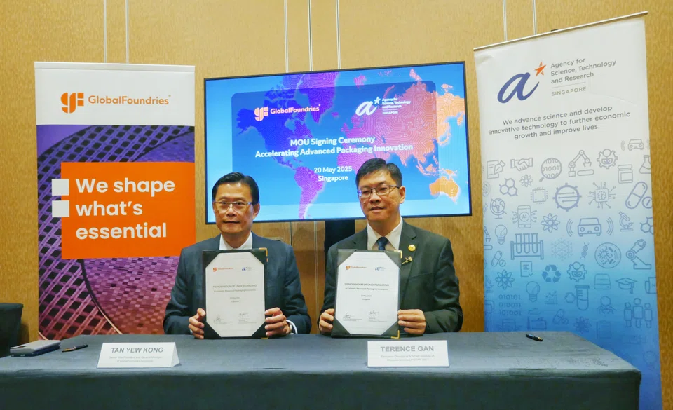 GlobalFoundries Singapore senior vice-president and general manager Tan Yew Kong (left) and A*Star Institute of Microelectronics executive director Terence Gan sign the MOU.