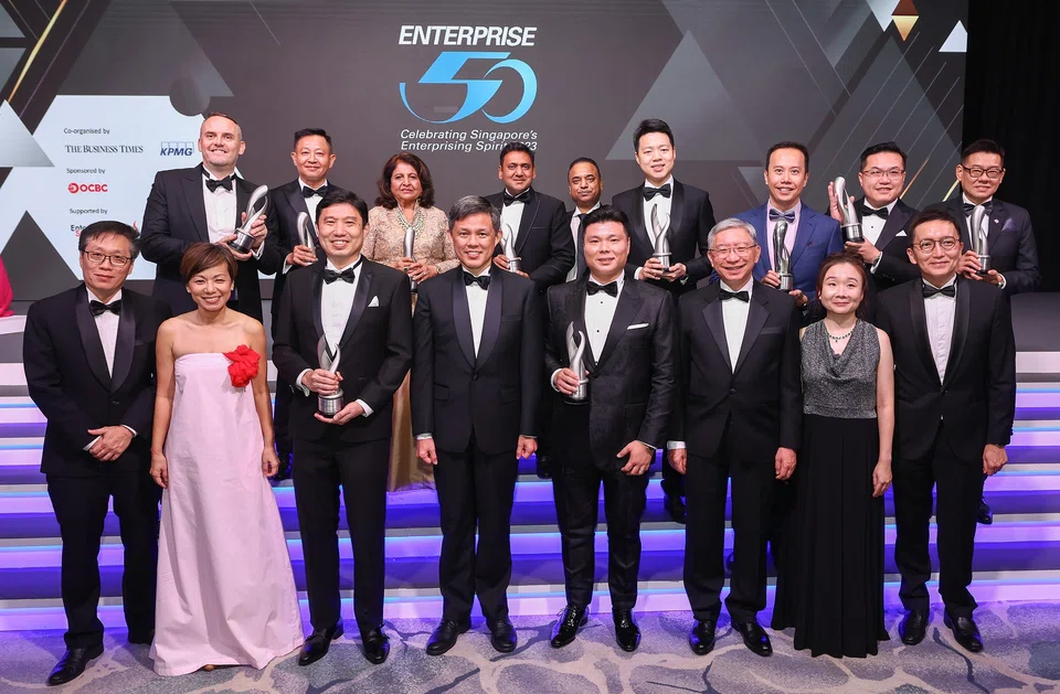 Guest of honour Minister Chan (fourth from left) with the top 10 E50 winners, as well as the event organisers and sponsor.