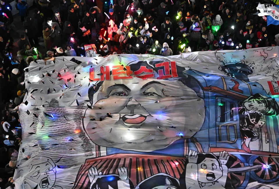 Protesters attending a candlelight vigil demanding the impeachment of South Korea President Yoon Suk-yeol on Dec 13.