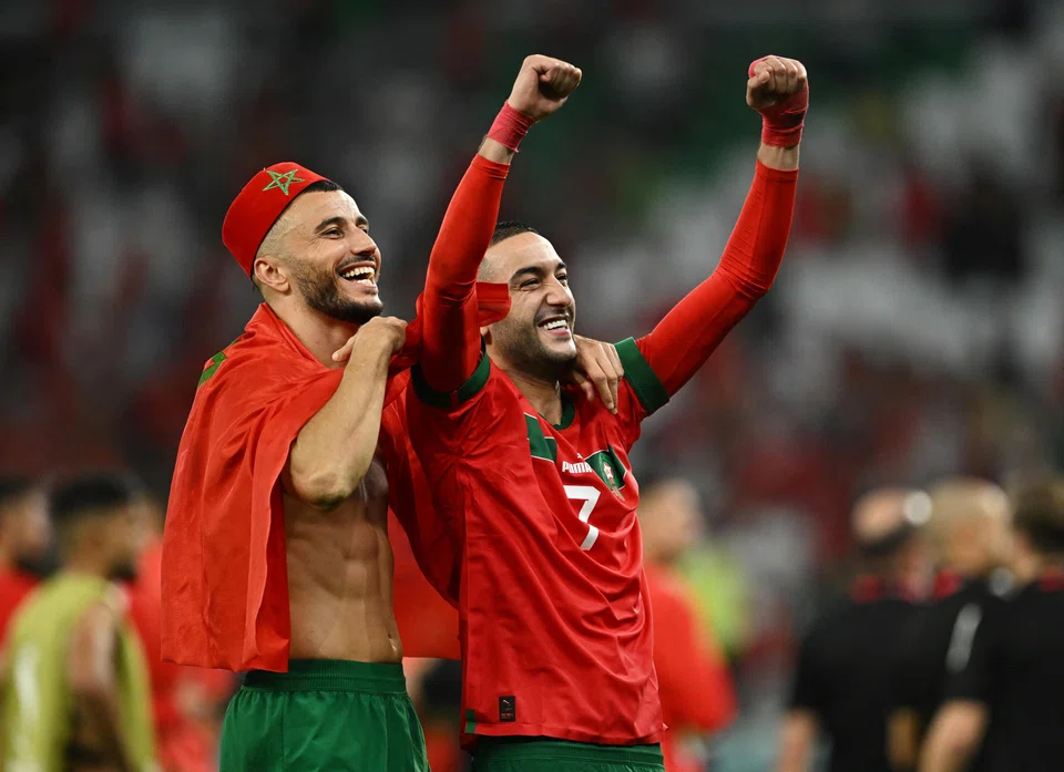 Morocco's Hakim Ziyech celebrates with Romain Saiss after the penalty shootout as Morocco beat Spain to progress to the quarter-finals, Rayyan, Qatar, Dec 7, 2022.