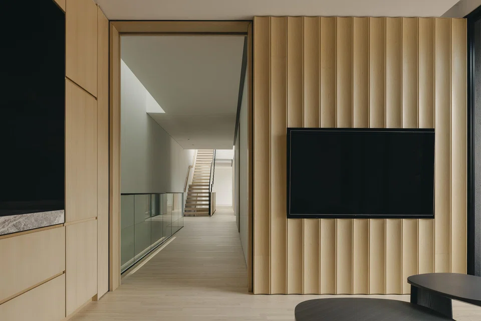The master bedroom lounge features fluted timber panels.