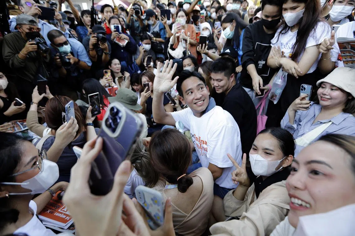 Pita Limjaroenrat (centre), the Move Forward Party's candidate for prime minister, greeting supporters during a campaign in Bangkok.