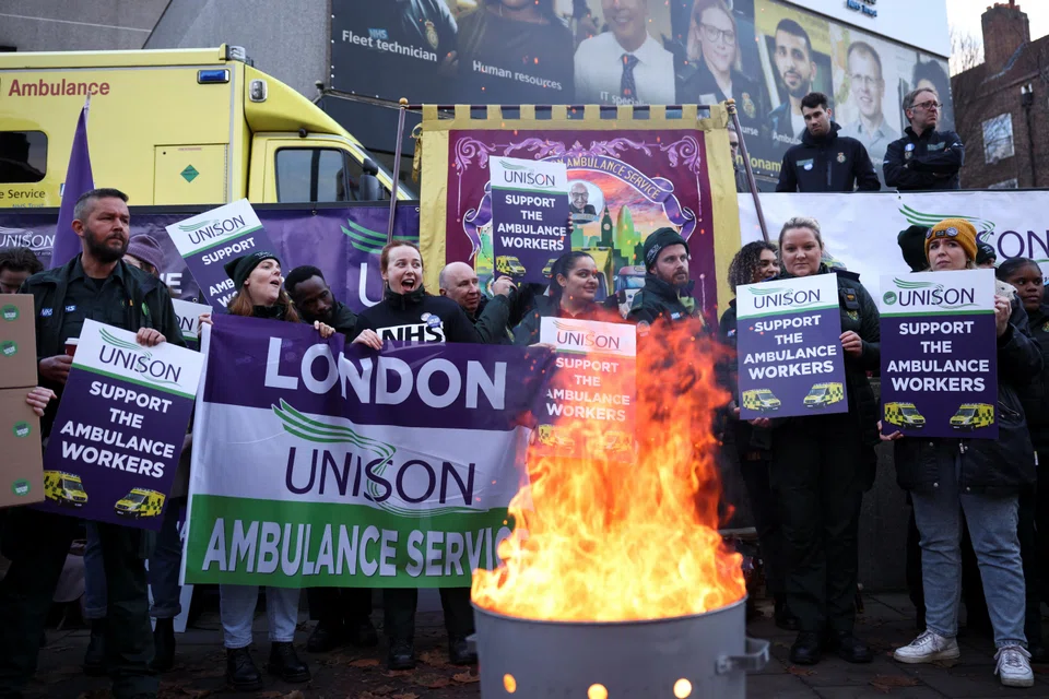 Ambulance workers take part in a strike over pay outside NHS London Ambulance Service in London last month.