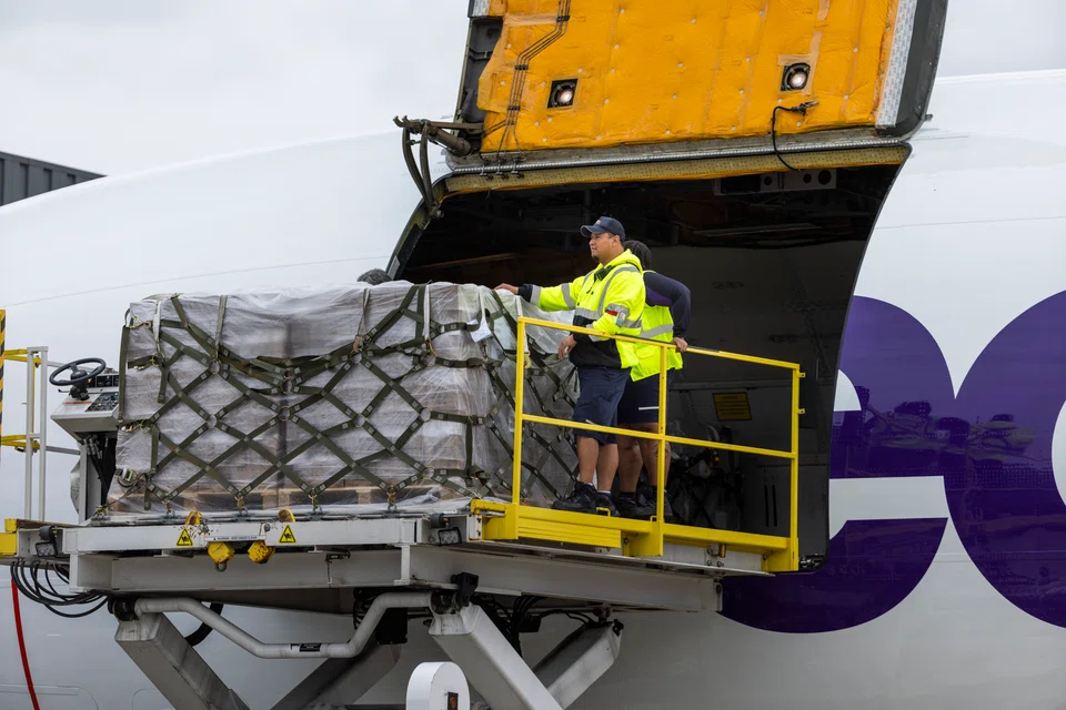 Workers unload a FedEx plane carrying the second shipment of baby formula under Operation Fly Formula at Dulles Airport in Chantilly, Virginia, USA, 25 May 2022. The US is facing a shortage of baby formula when contamination forced Abbott Laboratories to stop production of several brands of formula in February.  EPA-EFE/JIM LO SCALZO