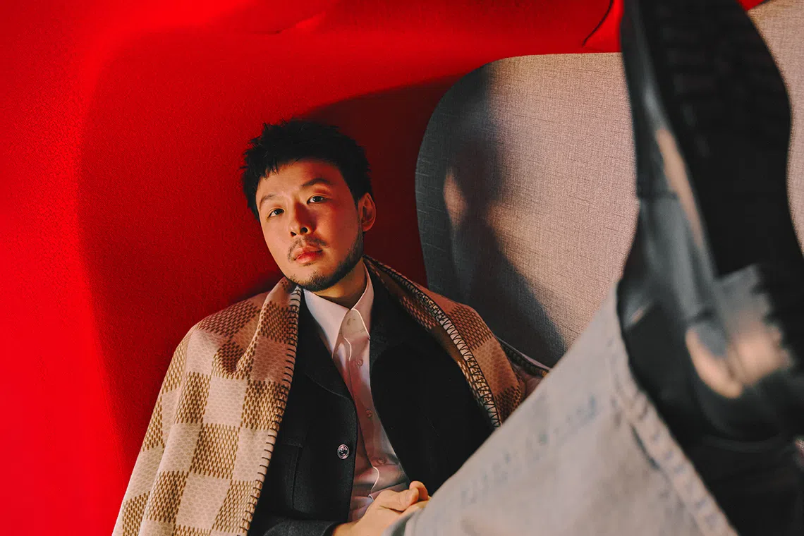 Kiat Lim may be the head honcho, but he's open to disagreements. He wears a grey jacket, denim jeans, wool blanket and cushion from Louis Vuitton.