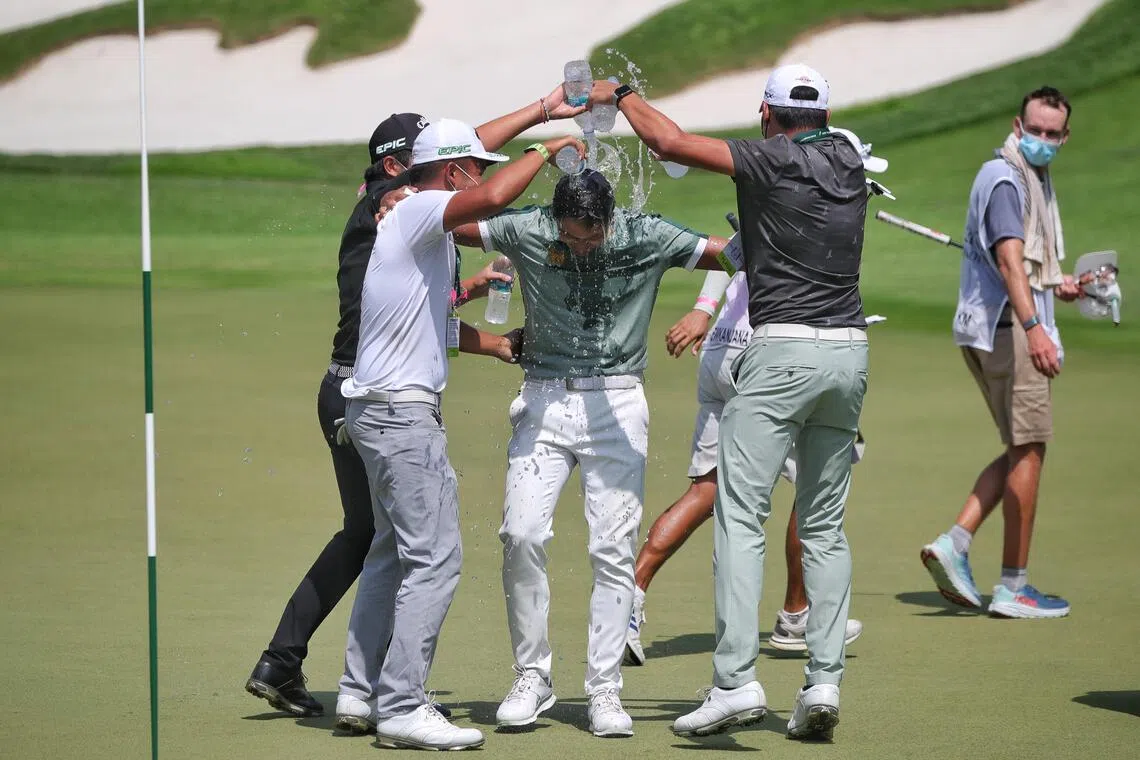 Sadom Kaewkanjana of Thailand being doused with water from his compatriots after winning the tournament at Sentosa’s Serapong Course in January 2022.