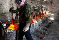 A worker at a smelting workshop prepares to pour the rare earth metal Lanthanum into a mould. The truce could see the Ministry of Commerce expedite approvals and even grant licences for US customers soon.