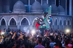 Palestinians celebrate in a street in Rafah, in the southern Gaza Strip, after Hamas announced it has accepted a truce proposal on May 6, 2024, amid the ongoing conflict between Israel and the Palestinian militant group Hamas.