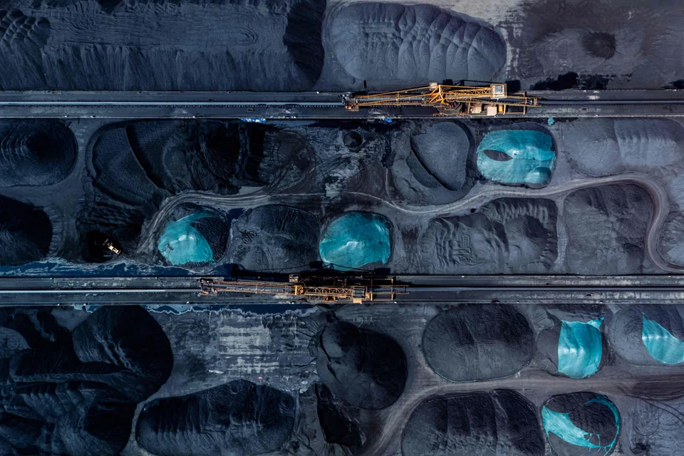 Machinery transferring coal at a port in southwestern China. Demand in the country is expected to fall slightly by 2030 as renewable capacity increases.