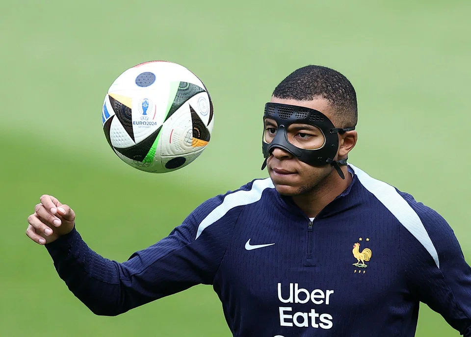 France's forward Kylian Mbappe, wearing a protective mask, at a training session at the Home Deluxe Arena Stadium in Paderborn, Germany, June 23, 2024.