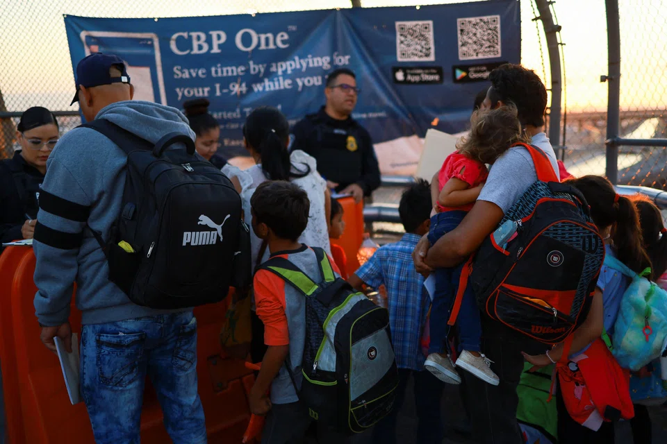 Migrants, seeking asylum in the United States and who previously requested an appointment on the US Customs and Border Protection (CBP) One application, attend their appointment at the Paso del Norte International border bridge, in El Paso, Texas. June 14, 2024. 
