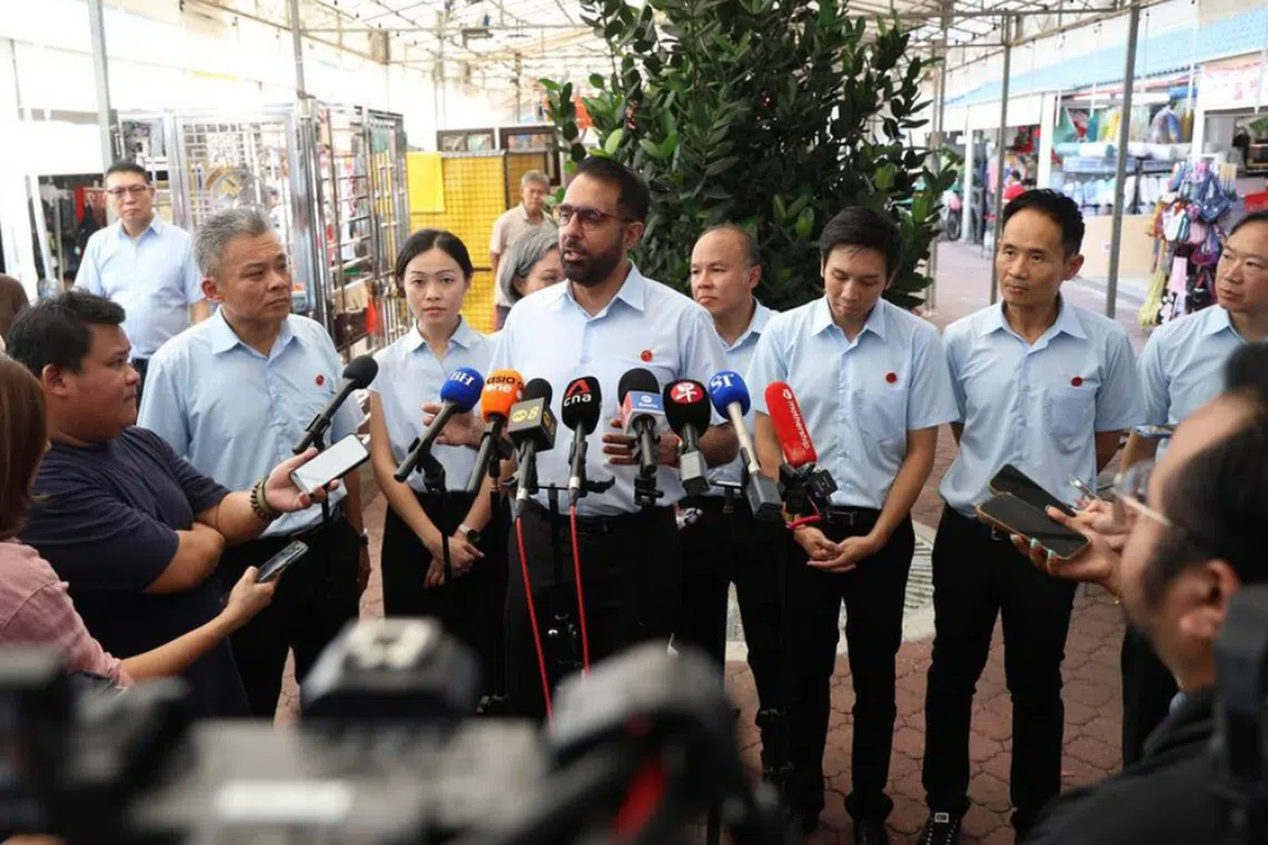 Workers' Party chief Pritam Singh (centre) speaking to the media during a doorstop in Tampines on April 28.