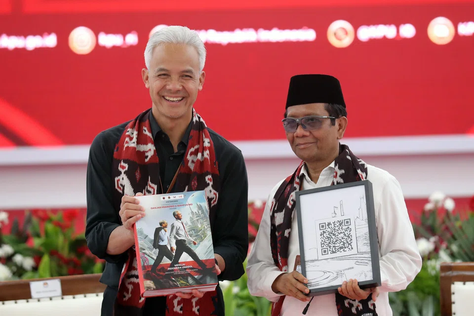 Ganjar Pranowo (left) has named Mahfud MD, a current law and security chief minister, as his running mate. 