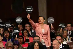 Progressive Democratic lawmakers protesting US President Donald Trump's address before Congress on Mar 4 by wearing pink to represent woman power, or holding up signs like “Musk Steals” and “Save Medicaid” to demonstrate their opposition.