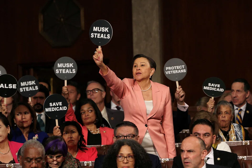Progressive Democratic lawmakers protesting US President Donald Trump's address before Congress on Mar 4 by wearing pink to represent woman power, or holding up signs like “Musk Steals” and “Save Medicaid” to demonstrate their opposition.