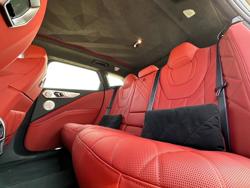 The back of the BMW XM is tremendously roomy, and the seats form a sort of wraparound lounge chair. 