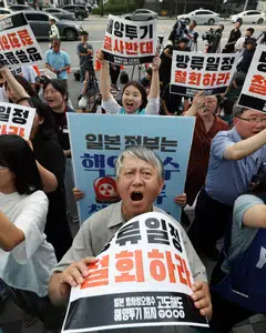 Protestors shout slogans during a rally in front of the Japanese Embassy in Seoul to call on the Japanese government; the government has launched a voucher programme offering up to 20,000 won to shoppers who buy seafood.