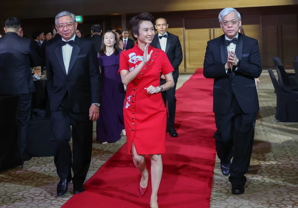 Guest of honour Low Yen Ling (in red), Senior Minister of State, Ministry of Culture, Community and Youth & Ministry of Trade and Industry, arriving at the gala event accompanied by the Emerging Enterprise award organisers. On her right is Linus Goh, head of global commercial banking, OCBC and Chan Yeng Kit, CEO, SPH Media is on her left. 