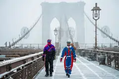 Pedestrians walk during a winter storm in the Brooklyn borough of New York, New York, Jan 25, 2026. 