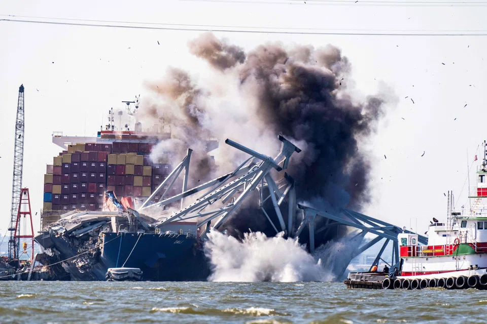 Crews conduct a controlled demolition of a section of the Francis Scott Key Bridge resting on the Dali container ship in Baltimore on May 13, 2024. The Francis Scott Key Bridge collapsed on March 26 when the Dali container ship lost power and collided into a support column, killing six roadway construction workers. 