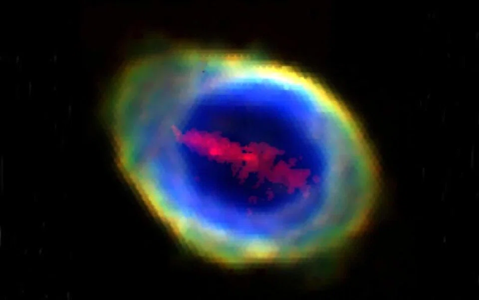 Researchers have spotted a large cloud of iron atoms in the shape of a bar stretching about 6 trillion km long across the face of the Ring Nebula (top).
