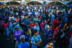 Displaced people queue for food at a temporary shelter amid clashes between Thailand and Cambodia along a disputed border area, Buriram, Thailand, Dec 16, 2025. 