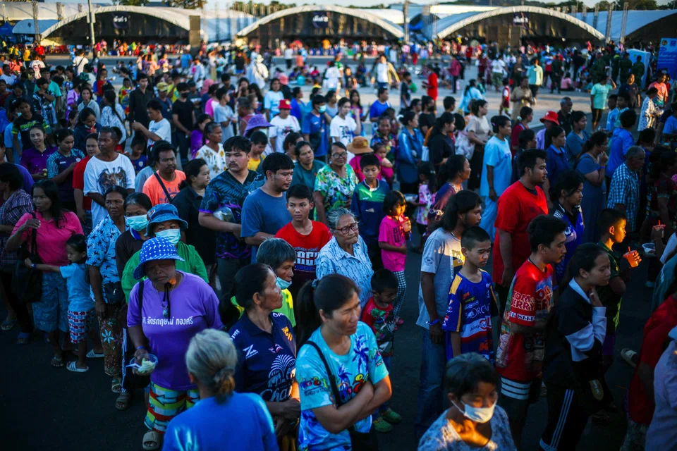 Displaced people queue for food at a temporary shelter amid clashes between Thailand and Cambodia along a disputed border area, Buriram, Thailand, Dec 16, 2025. 