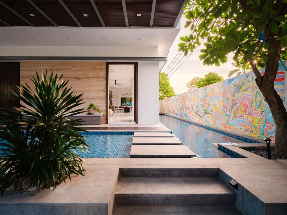 A mural depicting the family's memories is painted along a long boundary wall.