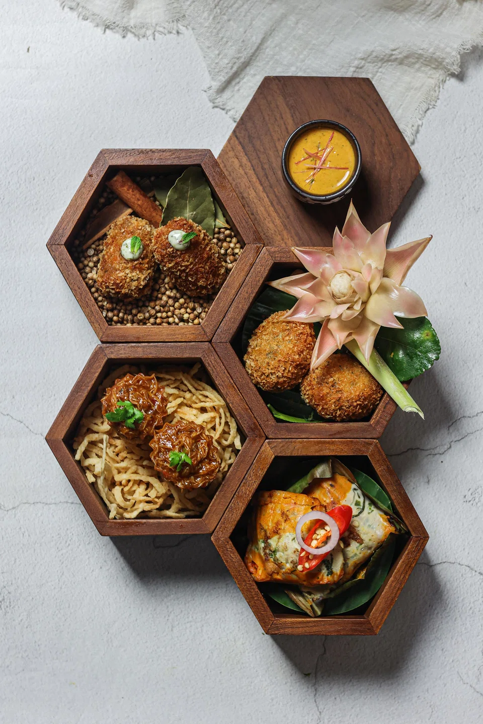 Tingkat of Memories is a quartet of snacks including otak and chilli crab kueh pie tee.