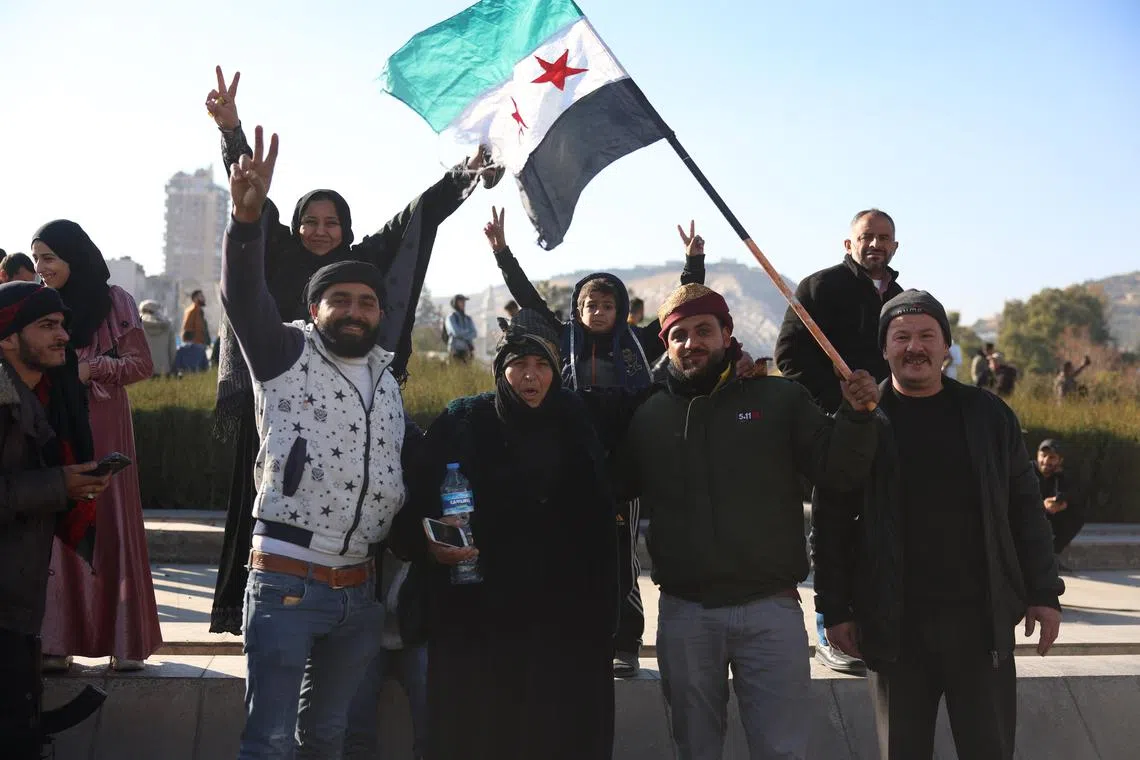 People celebrate after the fall of  President Bashar al-Assad in central Damascus, Syria, Dec 8, 2024. 
