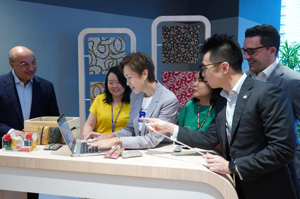 Minister for Communications and Information Josephine Teo (centre) at a demonstration by small business owners on the use of the chatbot Bard at the launch of the AI Trailblazers initiative on Jul 24. 