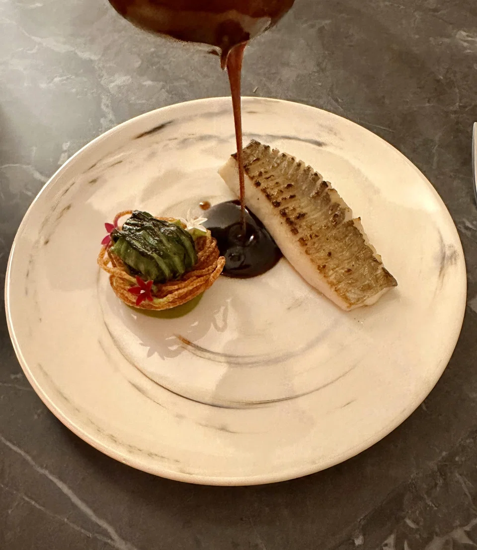 Grilled pomfret and pearl oyster in a potato nest.