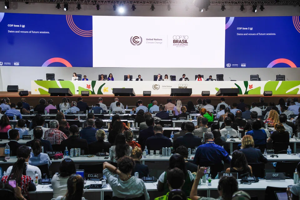 Attendees participate in the closing COP30 plenary session at the Hangar Convention Center in Belem on  Nov 22.