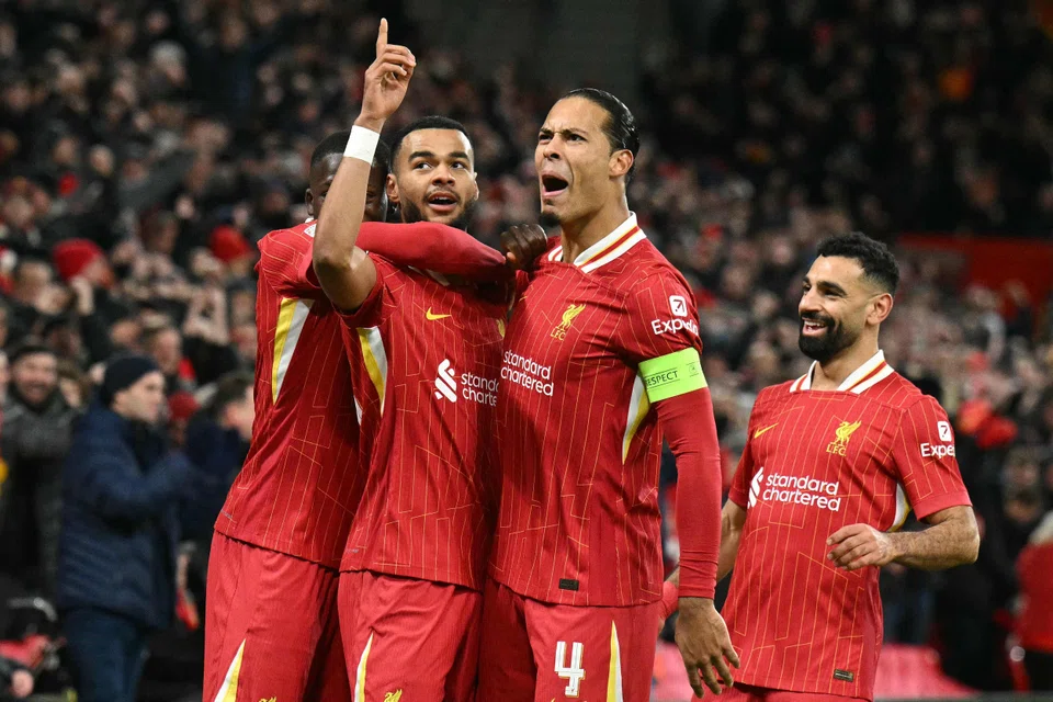 Liverpool striker Cody Gakpo (second from left) celebrates with Virgil van Dijk after scoring against Real Madrid in the Champions League on Nov 27, 2024.