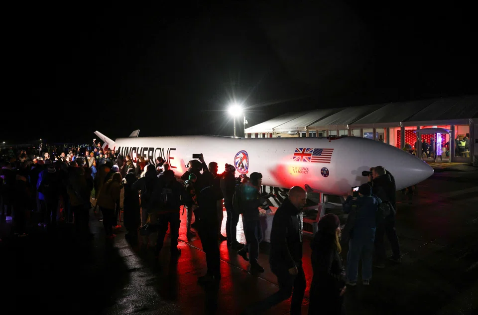 Spectators gather around a replica rocket at Cornwall Airport Newquay to watch the first ever UK launch of Virgin Orbit's LauncherOne rocket from Spaceport Cornwall in Newquay, Britain, Jan 9, 2023. 