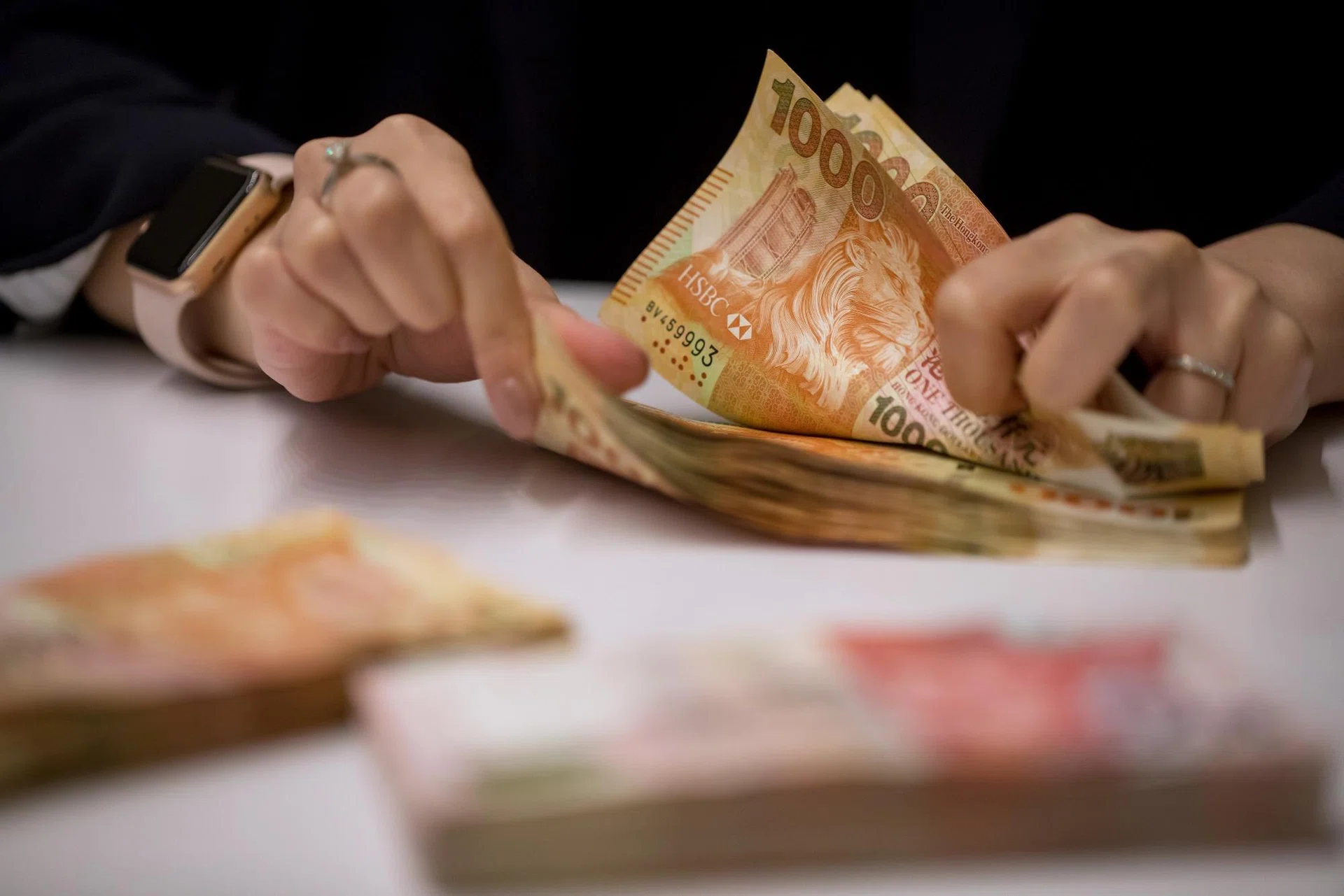 Hong Kong dollar slips as loose liquidity revs up carry trades