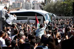 People gather to greet freed Palestinian prisoners as they arrive after being released from an Israeli jail as part of a hostages-prisoners swap and a ceasefire deal in Gaza between Hamas and Israel on Oct 13.