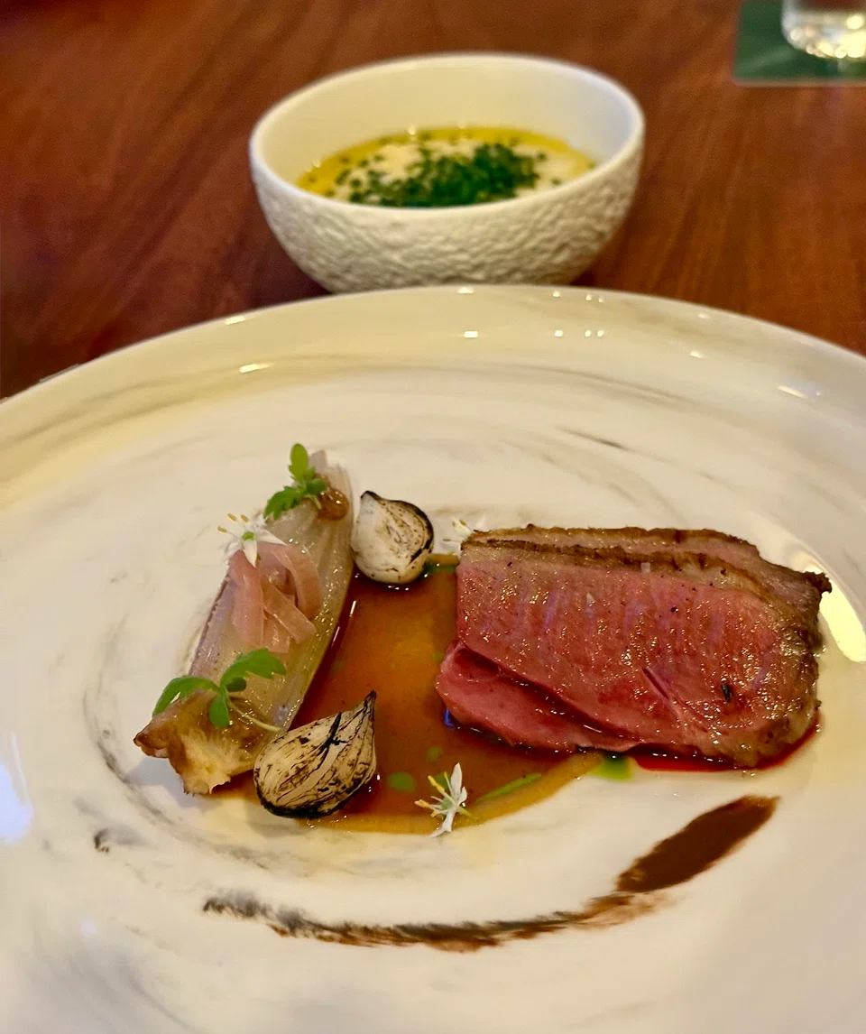 Roast Challans duck with creamy polenta.