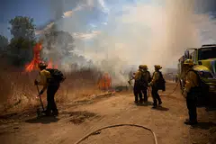 Firefighters work to contain the 'Woodley Fire' during a major heat wave in Los Angeles, California, Aug 21, 2025.  In a 440-page rebuttal, 85 scientists accused the Trump government of relying on a handful of contrarians who drew on discredited studies, misrepresented evidence, and bypassed peer review to reach pre-determined conclusions.