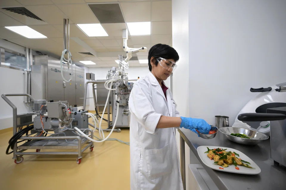 A scientist preparing salted egg CulinaPlant chunks at dsm-firmenich's new facility FutureBites, which was launched on Sep 18.