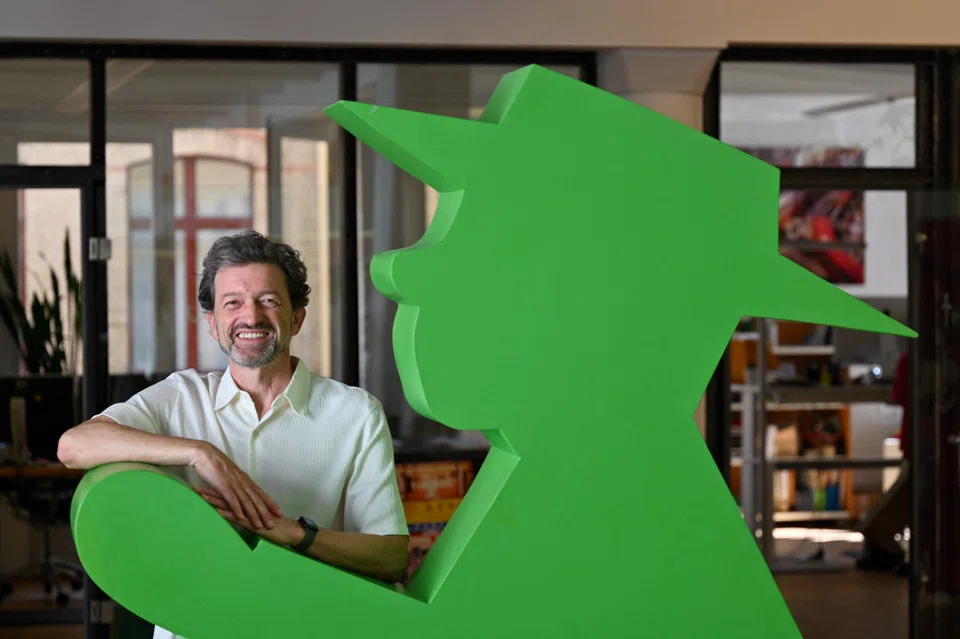 Markus Heckhausen, CEO of Berlin brand Ampelmann,  poses with a model of the East German traffic light man. 