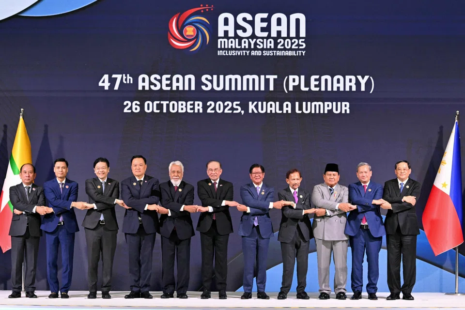 Asean leaders doing the Asean handshake – a symbol of unity – at the plenary session of the 47th Asean Summit on Oct 26.