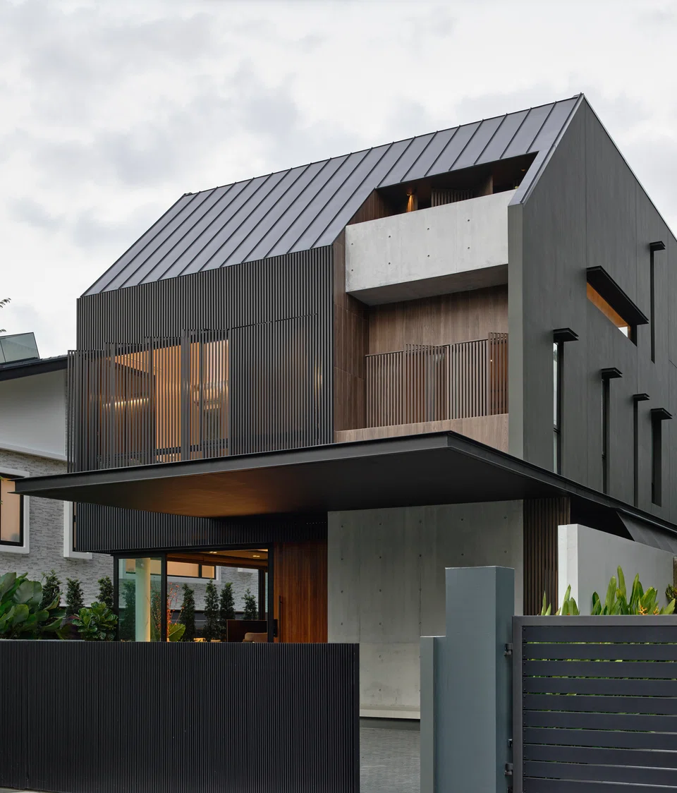 The house's facade uses screens for privacy and to provide shade from the sun.