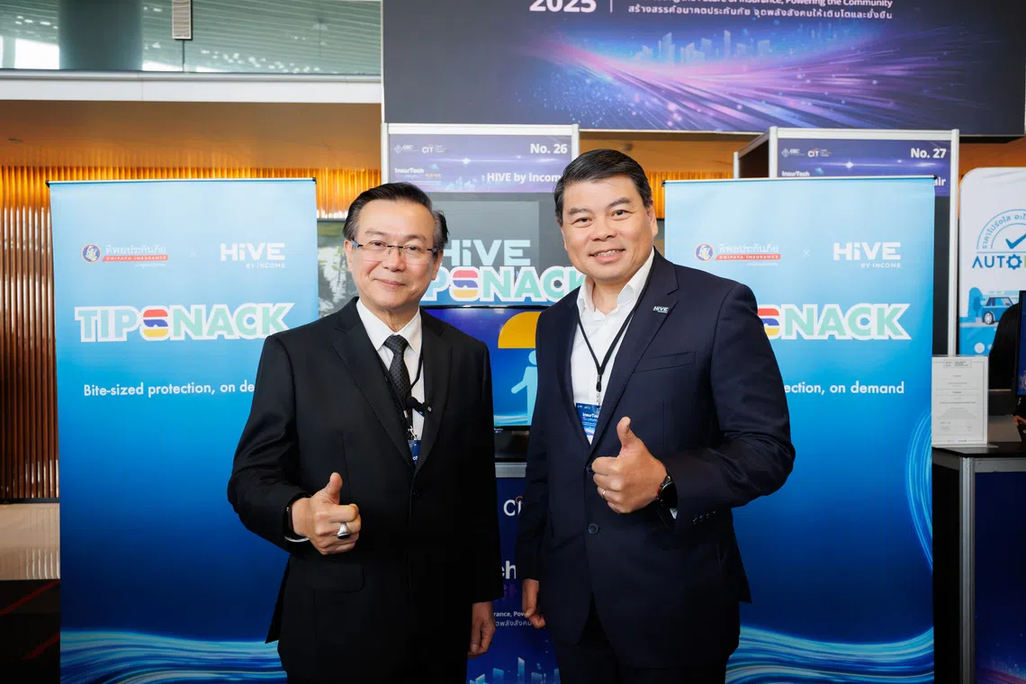 Dr Somporn Suebthawilkul (left), Dhipaya Insurance managing director, with Andrew Yeo, Income Insurance chief executive. Suebthawilkul hopes the new subscription-based micro insurance offering, TipSnack, will expand access to insurance among younger consumers. 