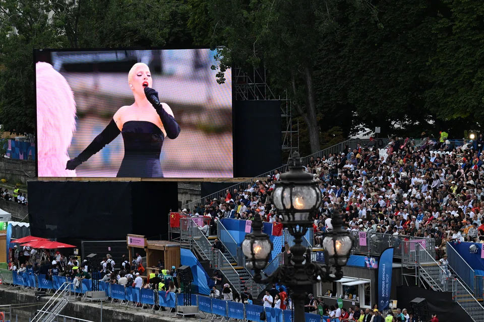 A video screen displays Lady Gaga performing during the opening ceremony of the 2024 Paris Summer Olympics along the River Seine in Paris, France, July 26, 2024. 