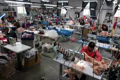 Employees work on sewing machines at the Midnight Charm Garment lingerie factory in Guanyun county of Lianyungang, Jiangsu province, China, Nov 25, 2024.